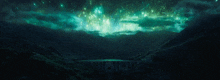 a bridge in the middle of a dark valley with fireworks exploding in the sky