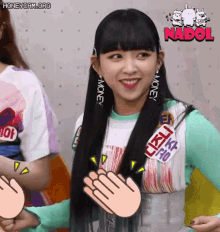 a girl with long black hair is smiling and applauding