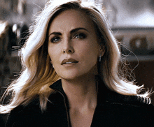 a close up of a woman 's face with a serious look on her face