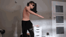 a shirtless man wearing sunglasses and a pair of pants that say medium on them