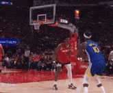 a basketball player with the number 10 on his jersey is playing against another player