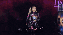a woman holding a stuffed animal with the name alexa bliss written on it