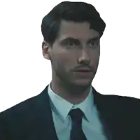 a man in a suit and tie is looking at the camera with a surprised look on his face