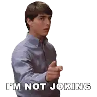 a man in a blue shirt says i 'm not joking while pointing