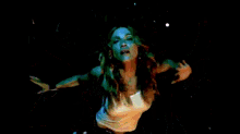 a woman is dancing in front of a crowd of people