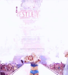 a wrestler is walking down a ramp in front of a wrestlemania sign