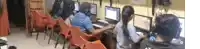 a group of people are sitting in front of computers .