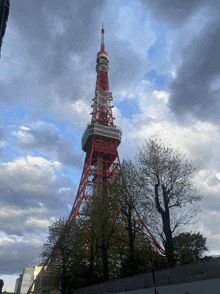 a tall red and white tower with a clock on top