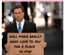 a man in a suit and tie holds a cardboard sign that says will make really good love to you for a place to stay