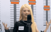 a woman with blonde hair and a name tag that says nova