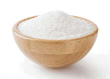 a wooden bowl filled with white powder on a white background