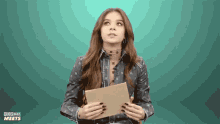 a woman holds a piece of paper in front of a green background that says pop jazz meets