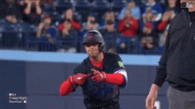 a baseball player wearing a jersey that says ' toronto ' on it