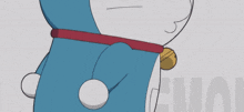 a close up of doraemon 's face with a red nose