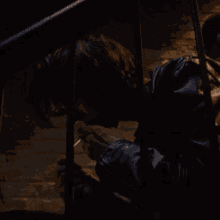 a person in a black leather jacket is sitting on a staircase