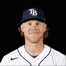 a baseball player wearing a hat with a tb logo on it