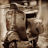 a vespa scooter is parked in the rain