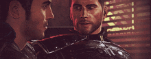 two men are looking at each other in front of a sign that says nexus