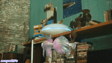 a room with a stack of cds on a shelf and a picture on the wall that says sn on it