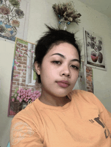 a woman wearing a yellow shirt with the letter l on the front