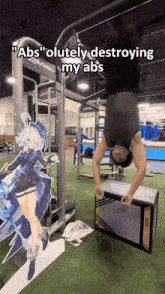 a man is doing a handstand in a gym with a picture of a girl behind him