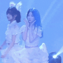 a girl in a white dress is standing in front of a blue light