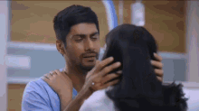 a man is hugging a woman in a hospital room .