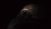 the letter q is surrounded by flames and a dark background