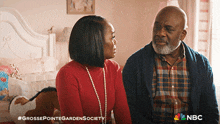 a man and a woman are sitting next to each other with a nbc logo on the bottom