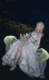 a woman in a long white dress is sitting on a plant