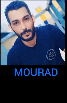 a man with a beard wears a black shirt with the name mourad on it