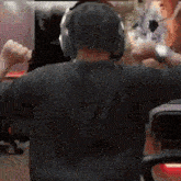 a man wearing headphones is sitting in a chair .
