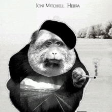 a monkey wearing a beret and smoking a cigarette with the name joni mitchell on the bottom right