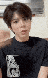 a young man wearing a black t-shirt that says crew