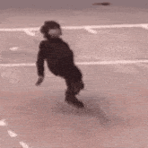 a person is doing a trick on the ground while a person walks by .