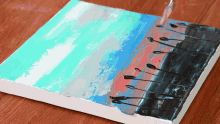 a painting of a sunset with palm trees is being painted