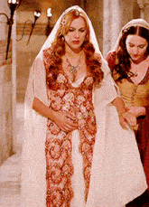 a woman in a white dress and a woman in a red dress are standing next to each other