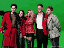 a group of people posing in front of a green screen that says anahioverdose on the bottom