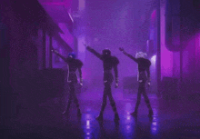 three anime characters are standing next to each other in a dark alleyway in a purple light .