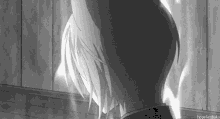 a black and white photo of a person 's back with a fire coming out of it .