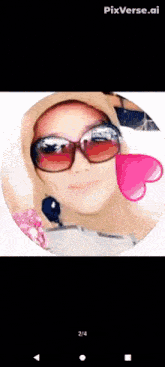 a woman wearing sunglasses and a hijab is in a circle with a pink heart in the middle