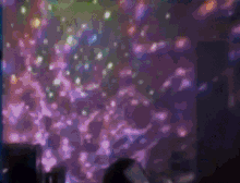 a blurred image of a party with a lot of lights on the wall