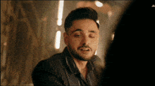a man with a beard is looking at the camera with jio written on the bottom right corner