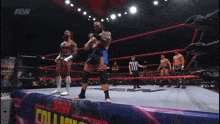 a group of wrestlers are standing in a ring with a sign that says aew