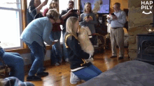 a group of people are gathered in a living room with hap pily written in the corner