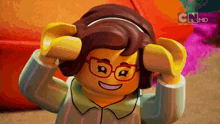 a lego girl wearing glasses and a headband with cnhd written on it