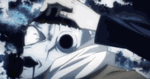 a person is putting a white mask on a person 's head .