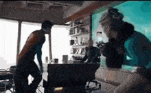 a man is standing next to a woman in a room .