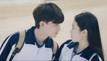 a boy and a girl looking at each other