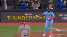 a baseball player in a blue jays uniform is about to swing his bat